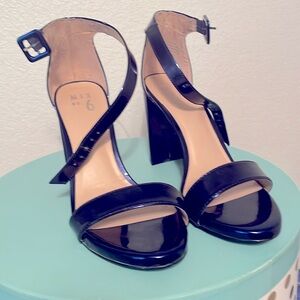 Shiny blue strappy heels.